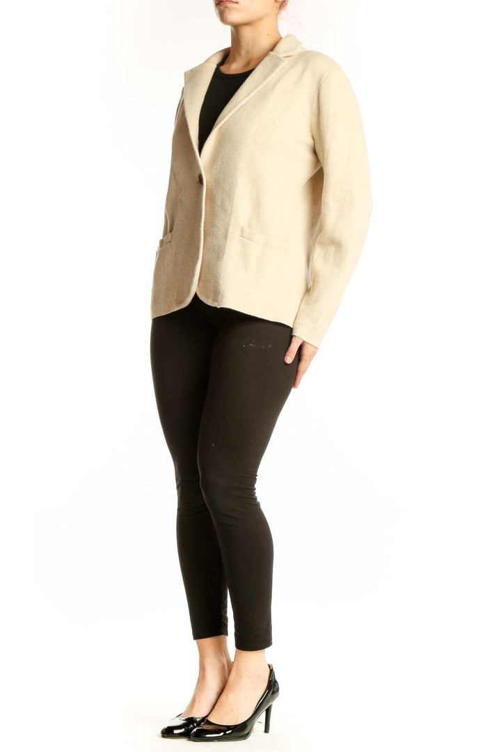 Front view of cream cotton knit blazer by J.Crew with single-button closure and front pockets, worn over black top