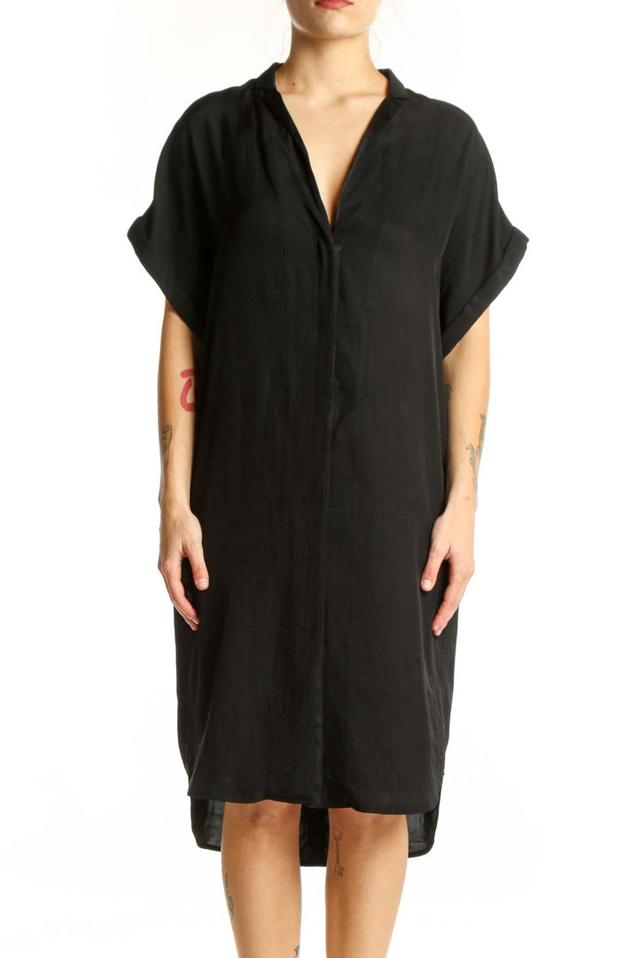 Black button-front shirt dress with rolled sleeves and relaxed fit, front view