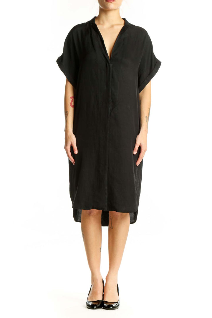 Black button-front shirt dress with rolled sleeves and relaxed fit, front view