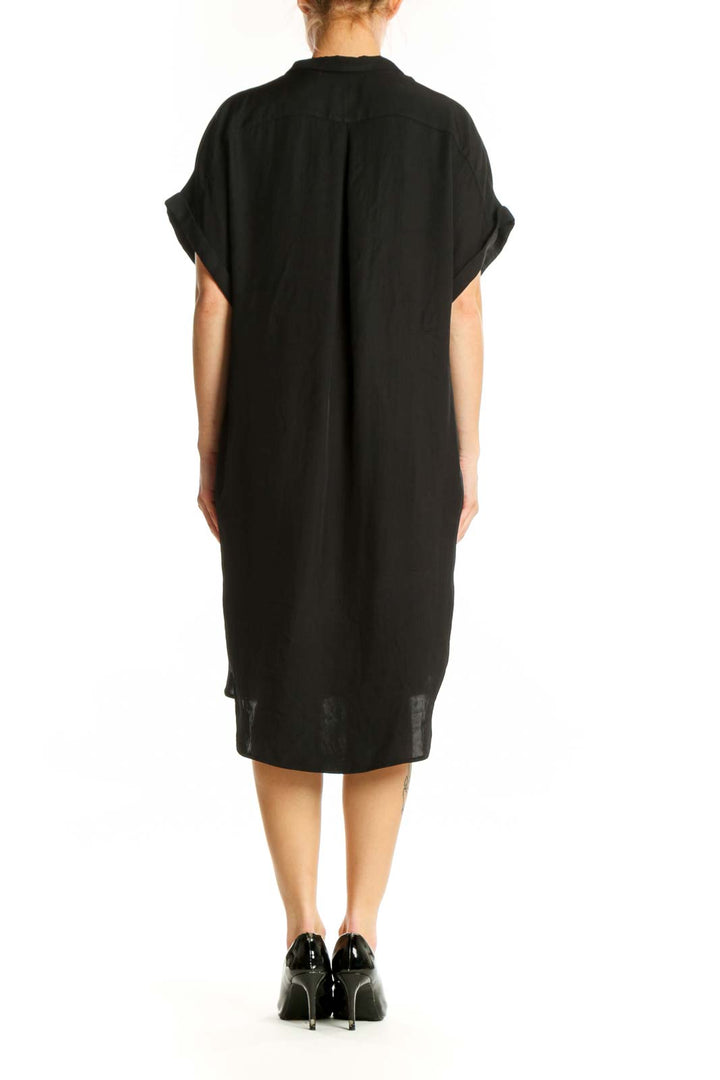 Black button-front shirt dress with asymmetrical hem, back view