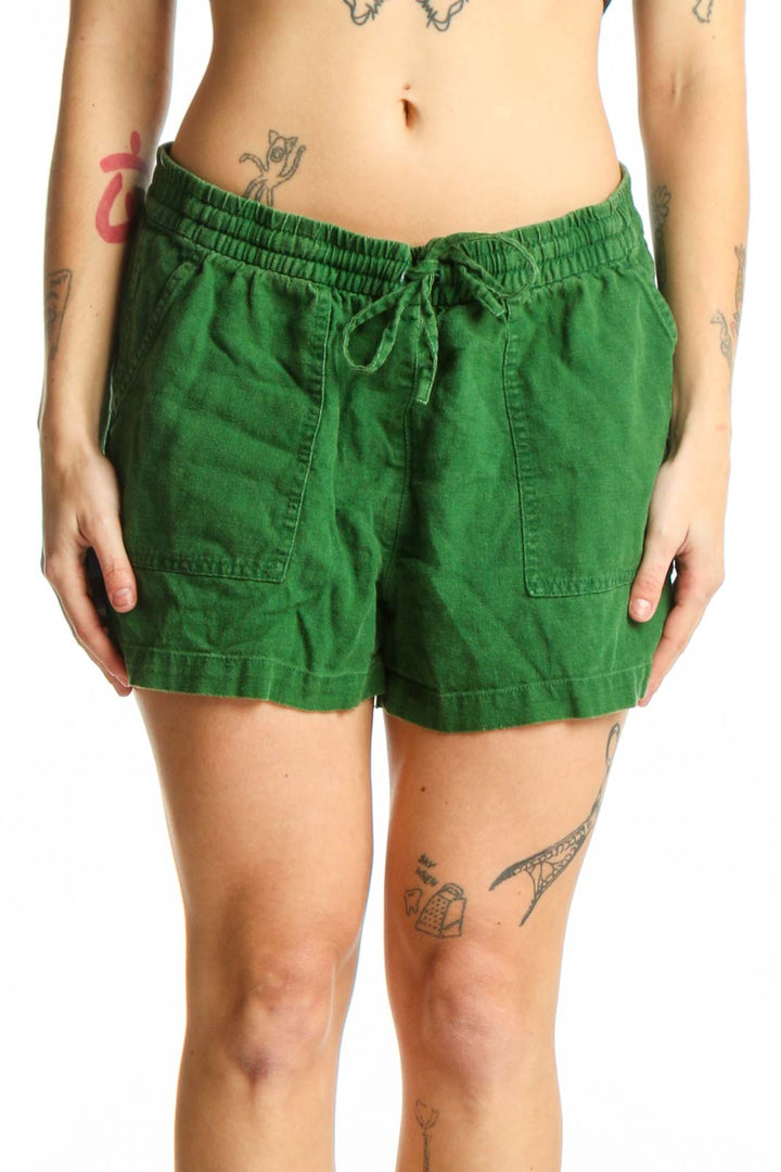 Front view of green linen viscose drawstring shorts with elasticized waistband and patch pockets