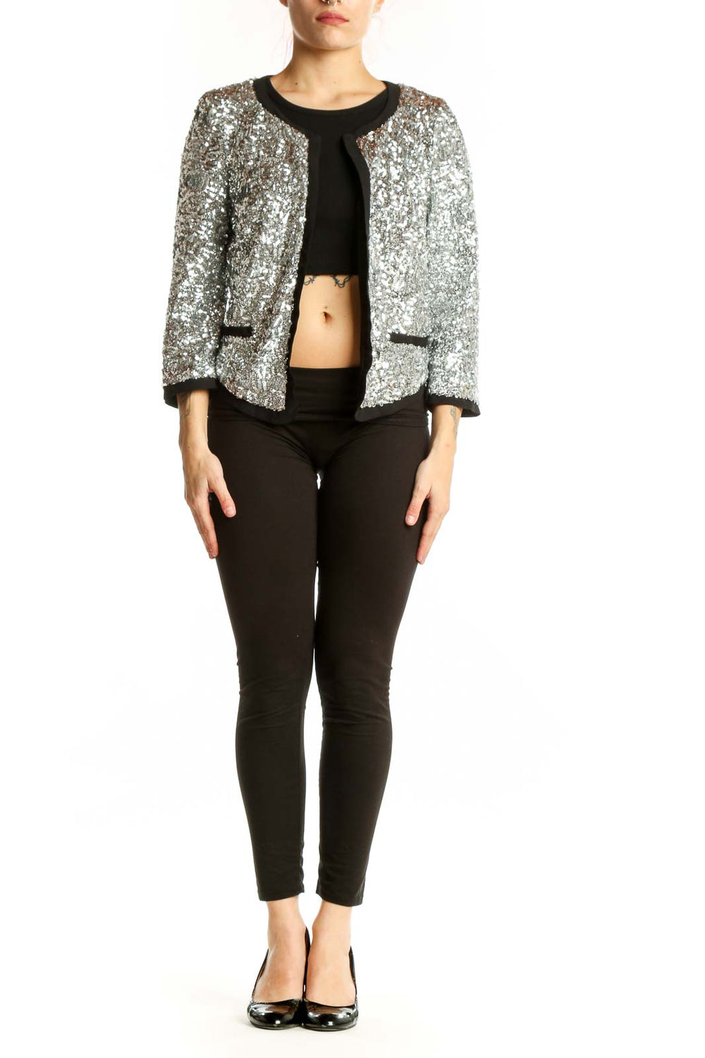 Silver sequin cropped jacket with black trim and open-front design, worn with black crop top and pants