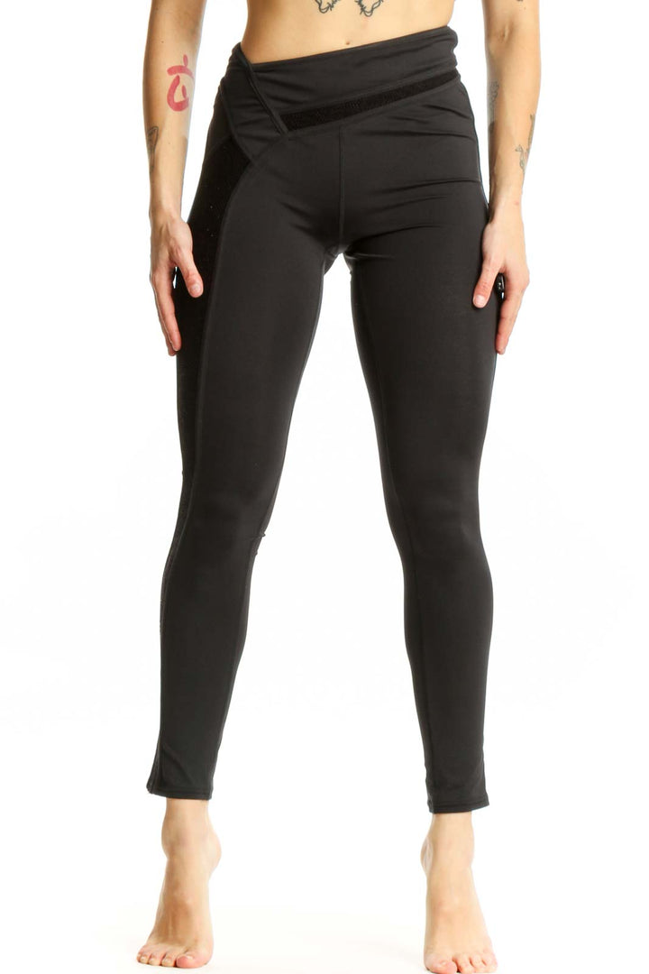 Black wrap waist activewear leggings front view, XS size, showing high-waisted design and cropped length