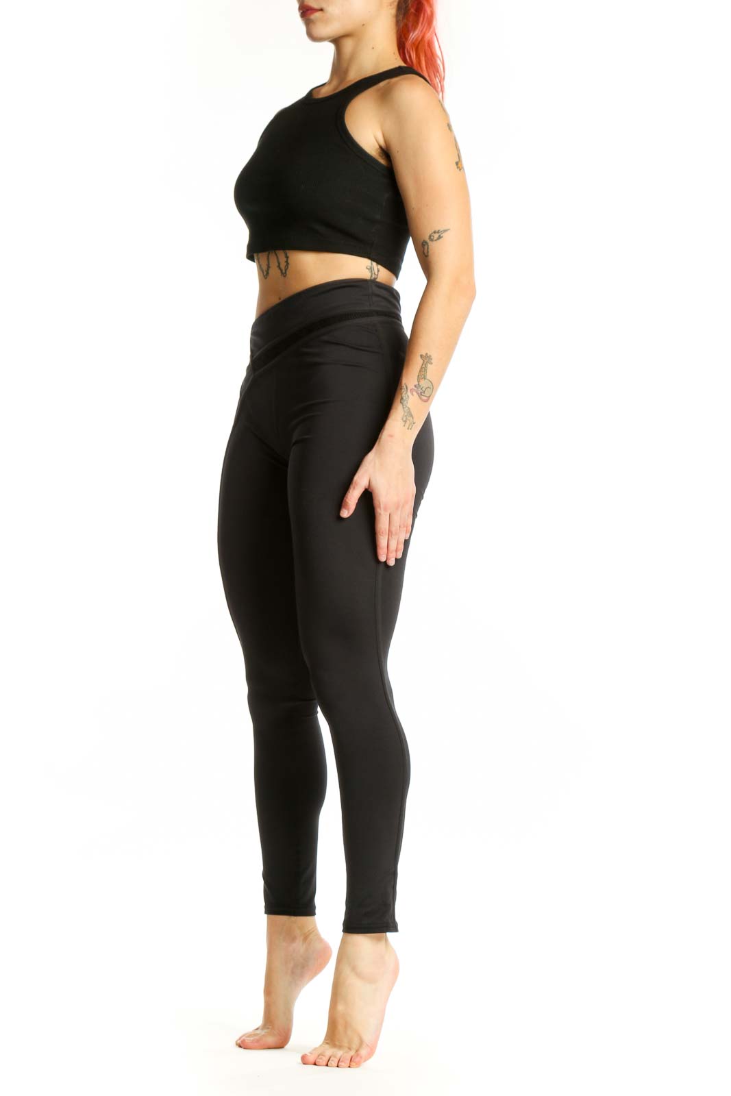 Black wrap waist activewear leggings front view, XS size, showing high-waisted design and cropped length
