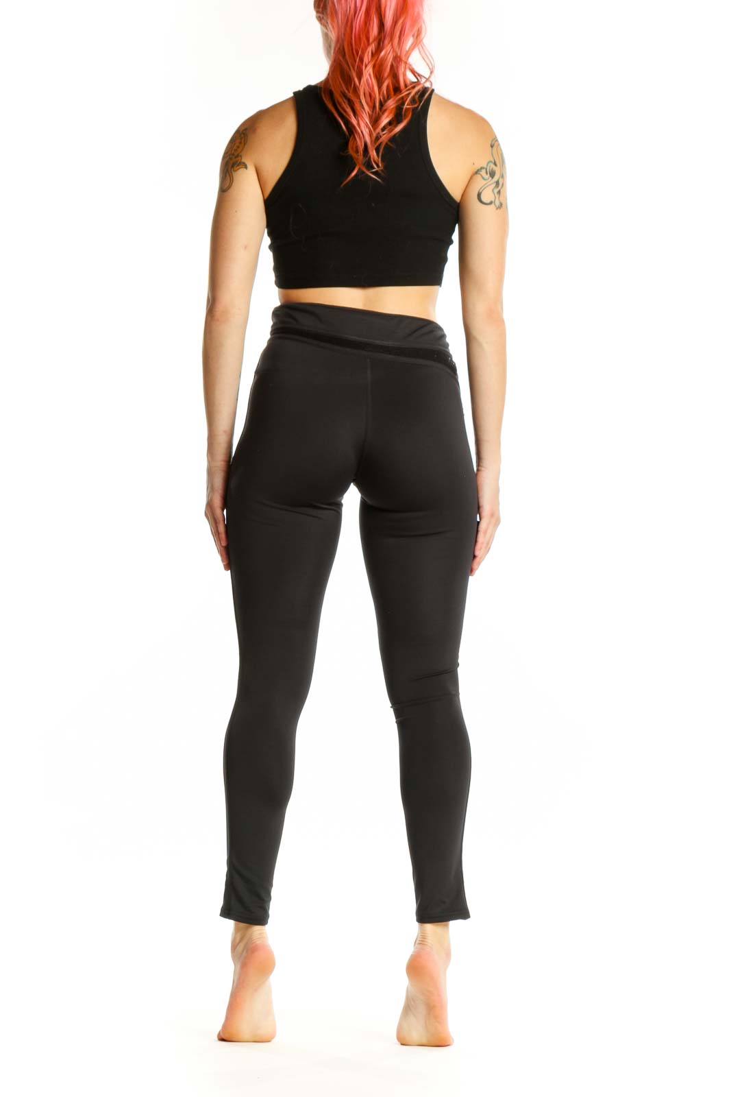 Black wrap waist activewear leggings back view, XS size, displaying form-fitting silhouette and wrap waist detail
