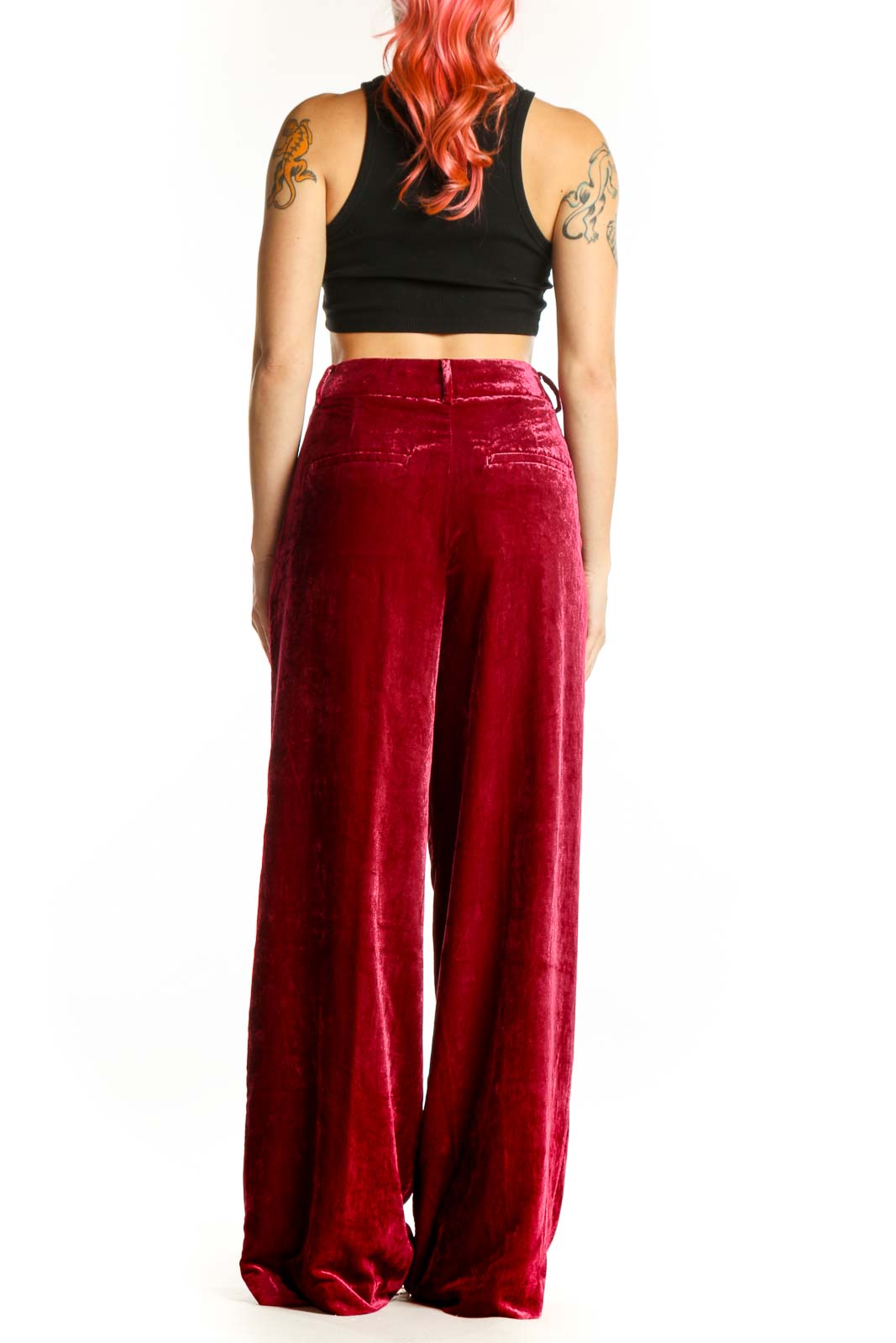 Back view of red velvet wide-leg pants showing flowing silhouette and draping