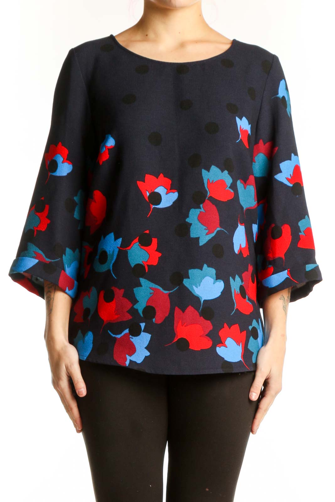 Navy floral print top with red and blue blooms, three-quarter sleeves, crew neckline, front view on model