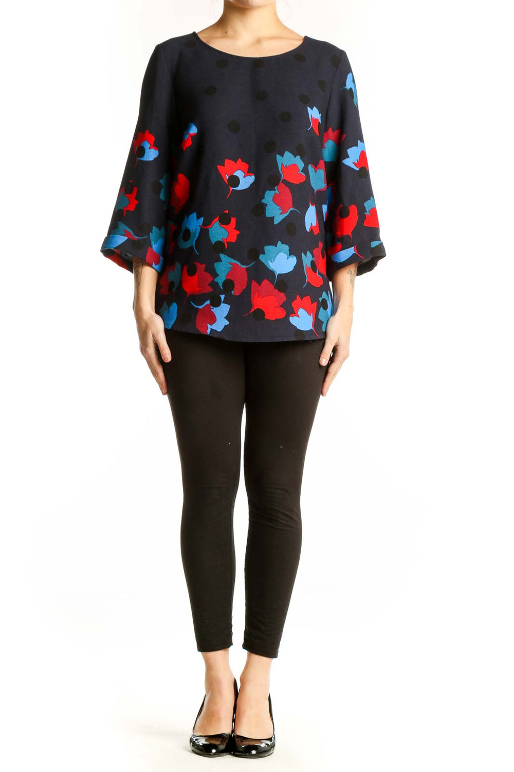 Navy floral print top with red and blue blooms, three-quarter sleeves, crew neckline, front view on model