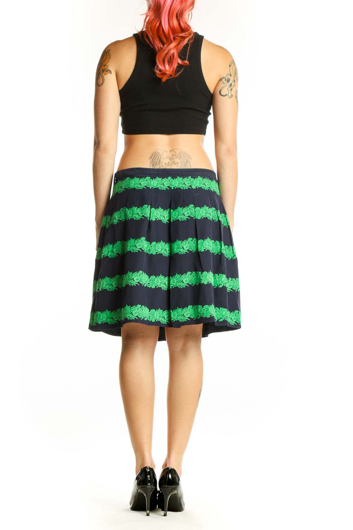 Back view of green and black striped pleated knee-length skirt by J.Crew showing pleated construction