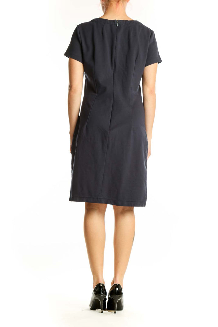 Black short sleeve t-shirt dress with A-line cut, back view showing simple elegant silhouette