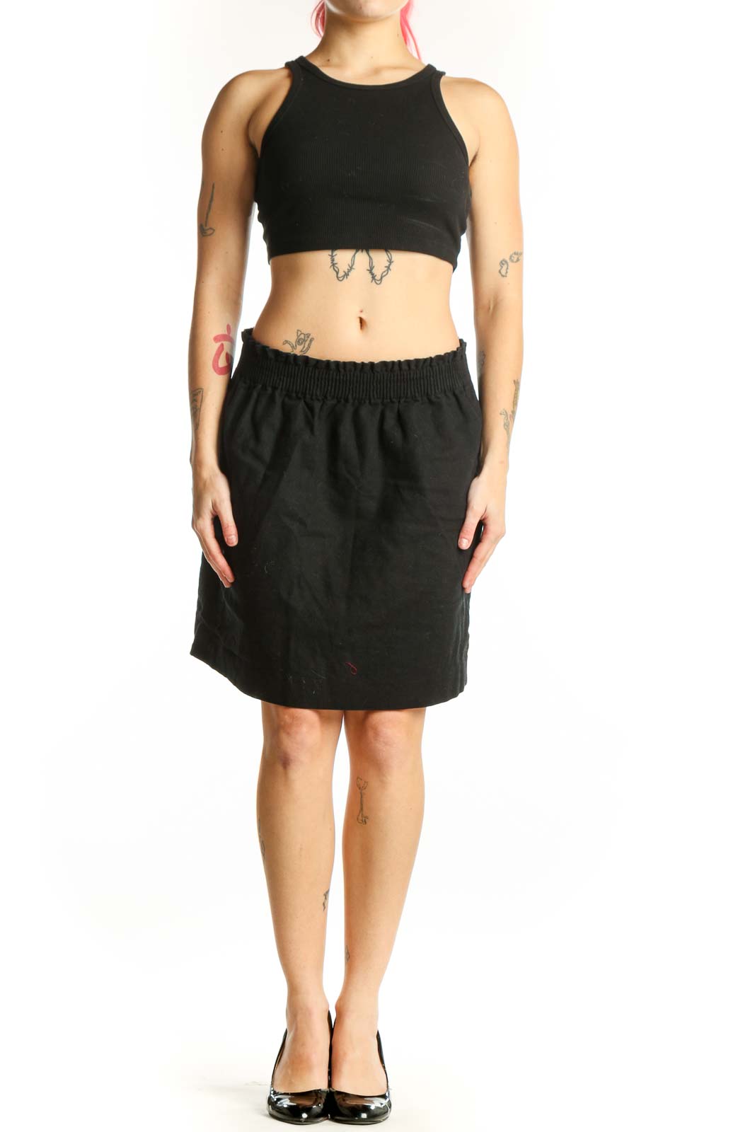 Black cotton-polyester mini skirt with elasticized waistband and side pockets, front view