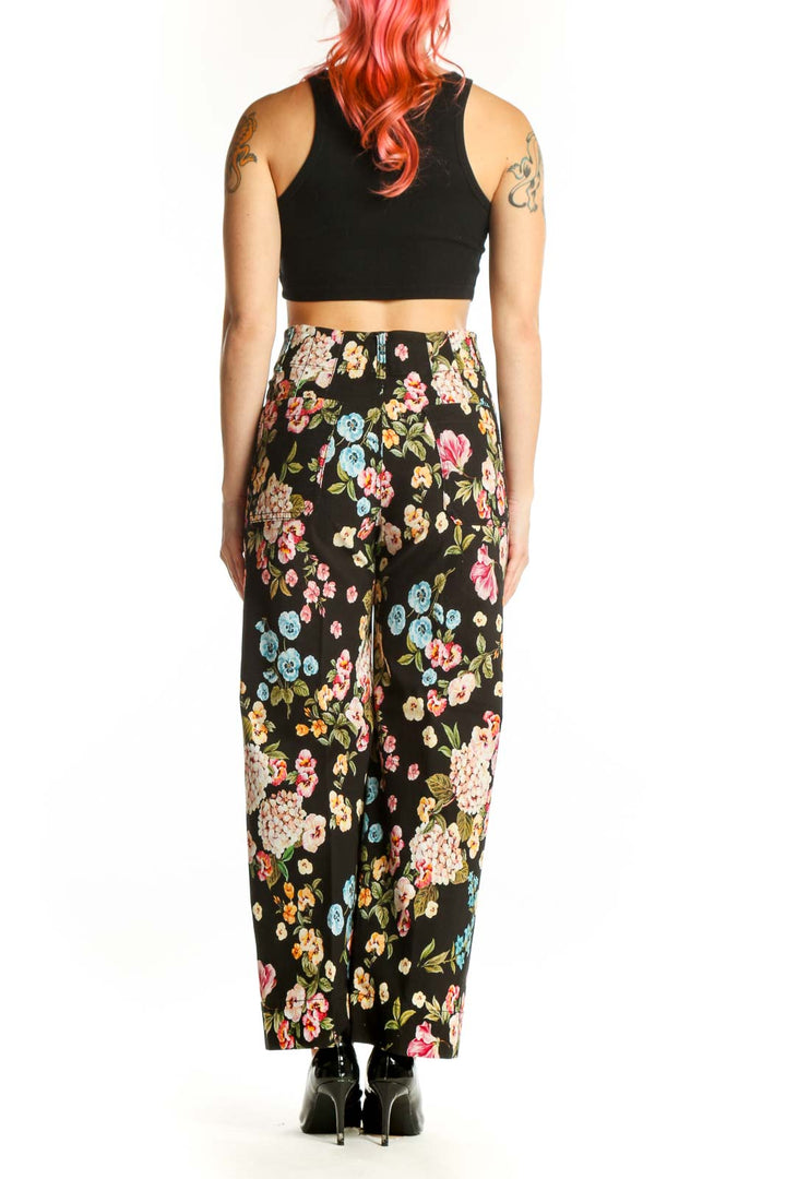 Black floral wide-leg pants with multicolor botanical print, high-waisted fit, back view
