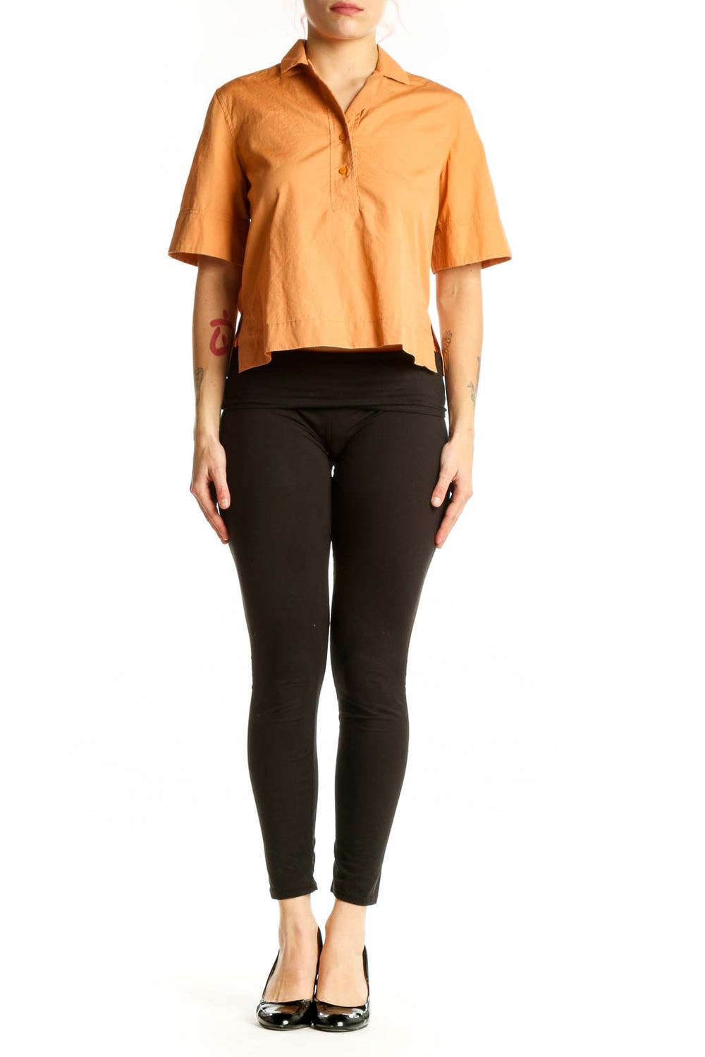 Orange cotton short sleeve polo shirt with button-front closure and cropped silhouette