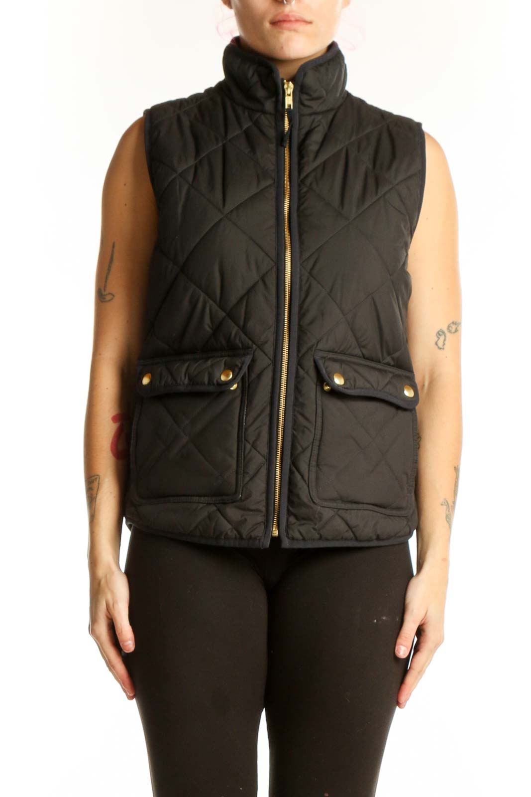 Black quilted puffer vest by J.Crew with diamond quilting pattern, gold-tone zipper, and functional front pockets