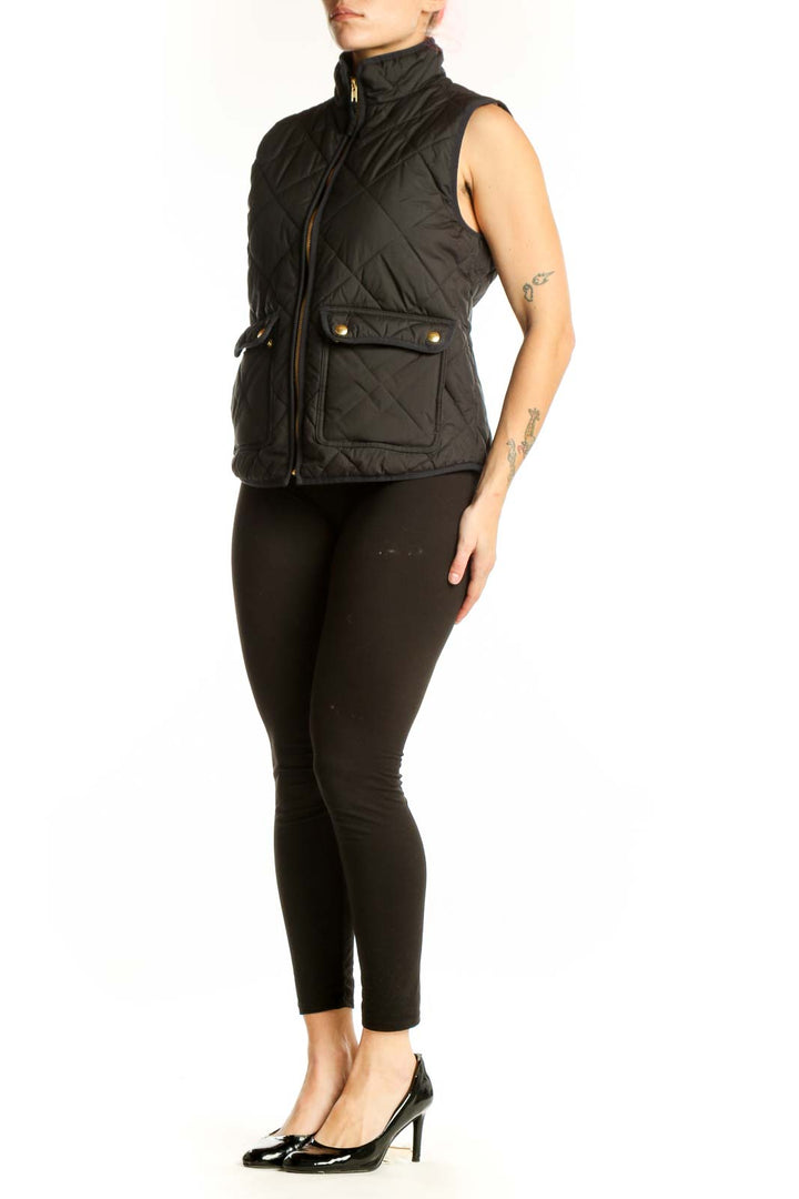 Black quilted puffer vest by J.Crew with diamond quilting pattern, gold-tone zipper, and functional front pockets