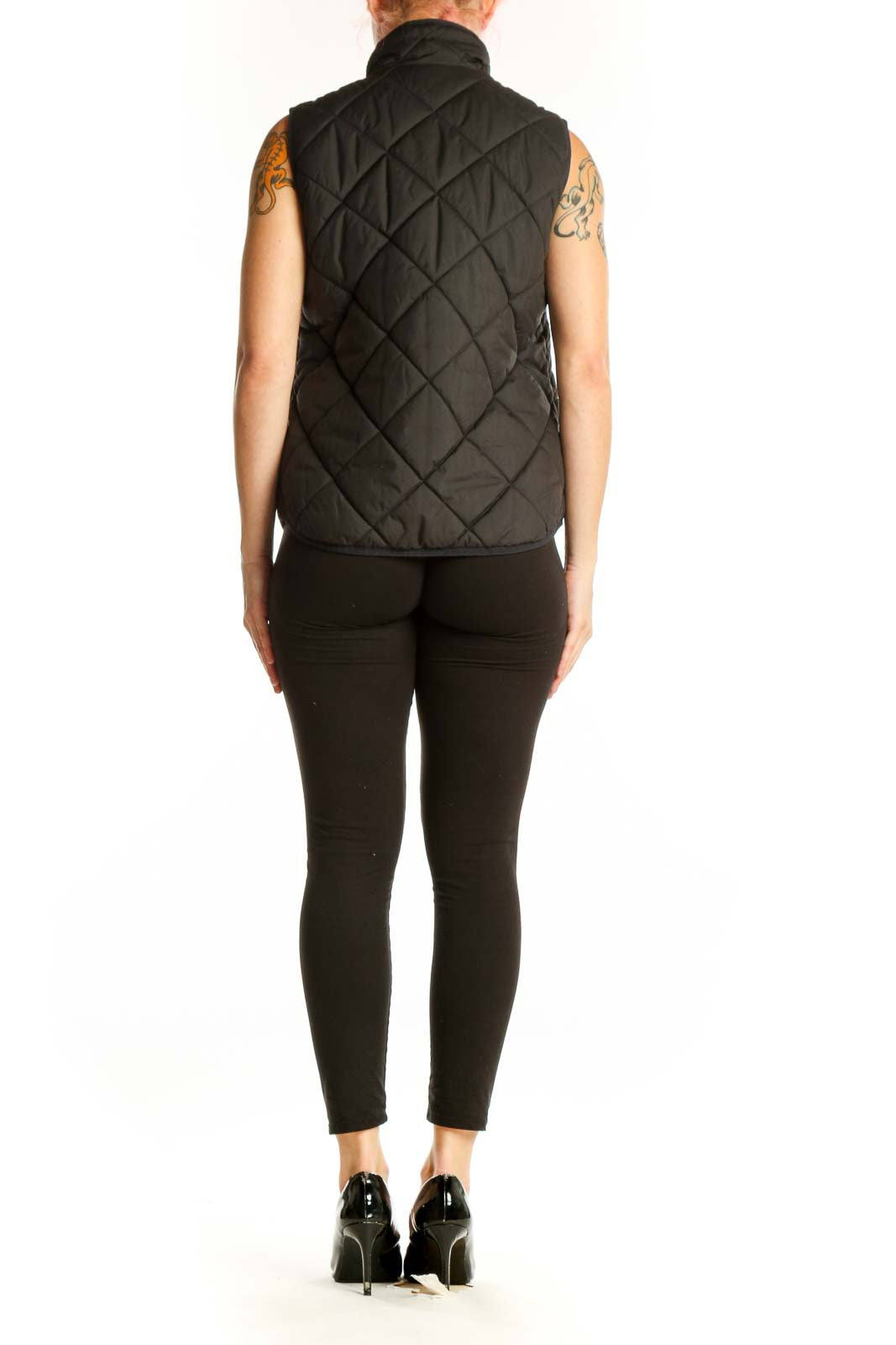 Back view of black quilted puffer vest showing diamond quilted design and gold-tone hardware details