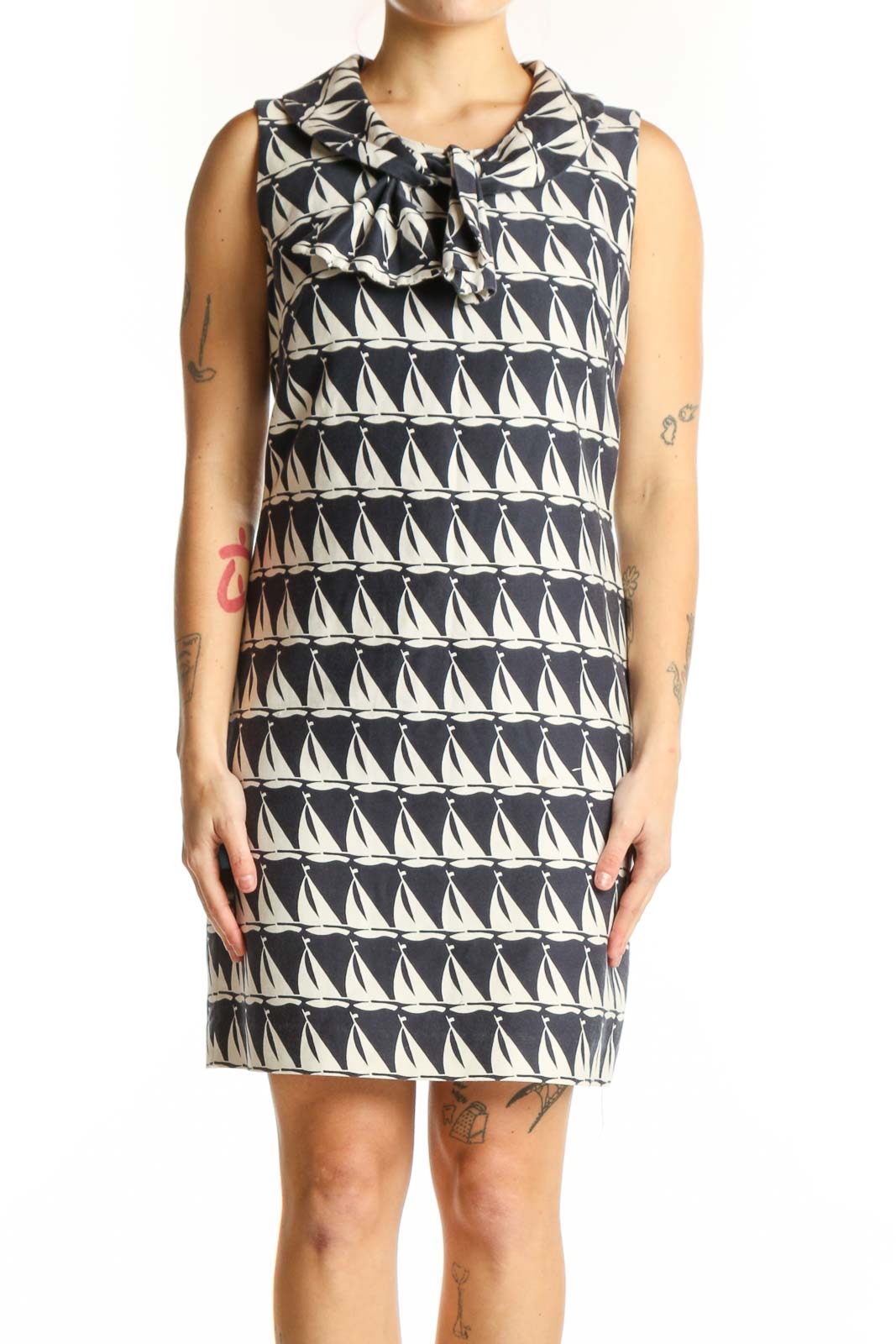 Black and white geometric triangle print Milly shift dress with bow neckline, front view on model