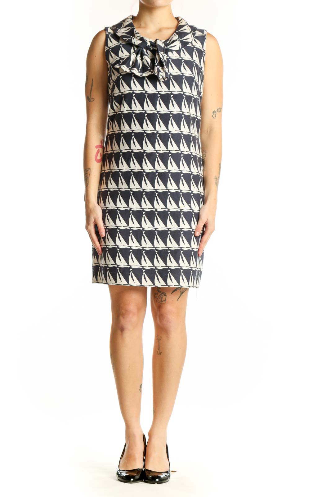 Black and white geometric triangle print Milly shift dress with bow neckline, front view on model