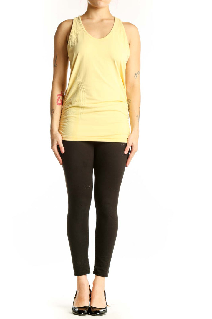 Yellow ruched athletic tank top with scoop neckline, front view on model