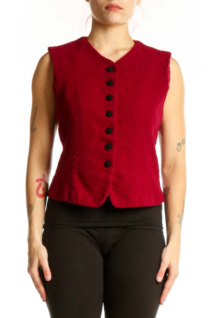 Red wool sleeveless button vest with V-neckline and black buttons, worn with black pants