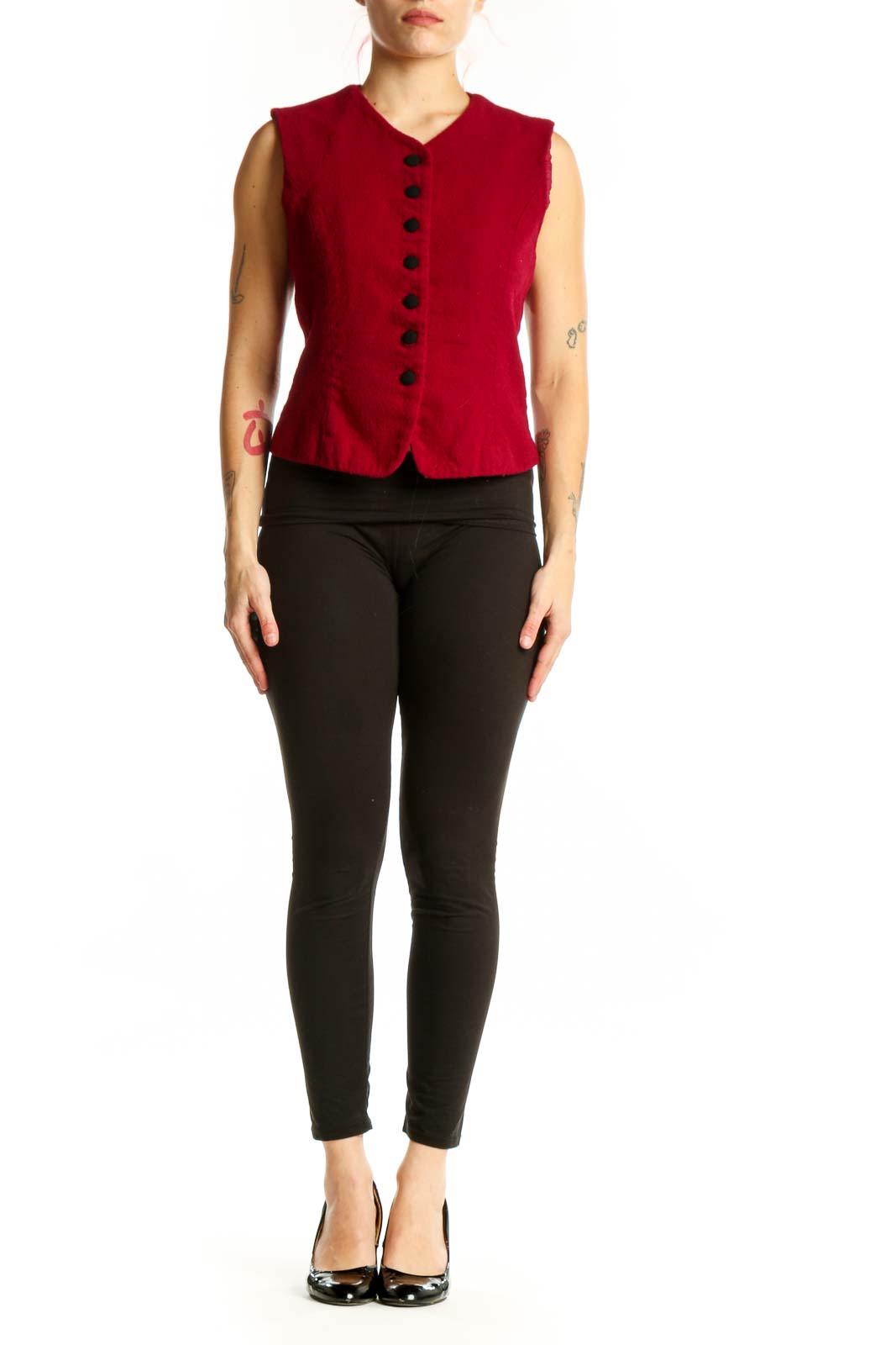 Red wool sleeveless button vest with V-neckline and black buttons, worn with black pants