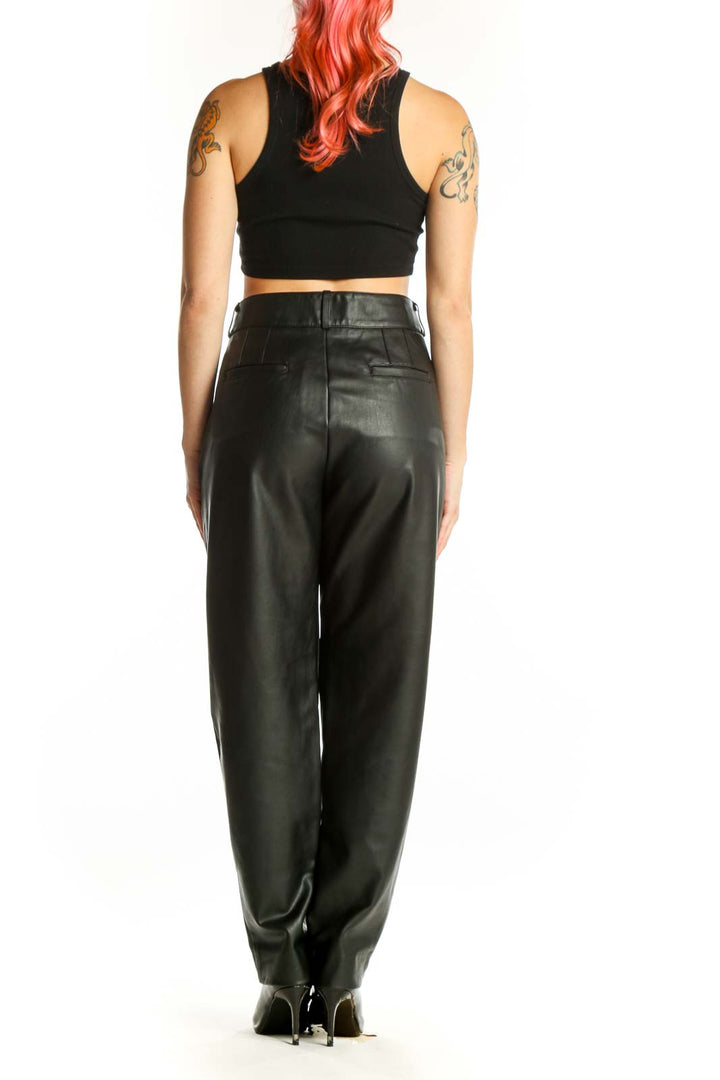 Back view of black leather tapered pants showing clean lines and flattering silhouette