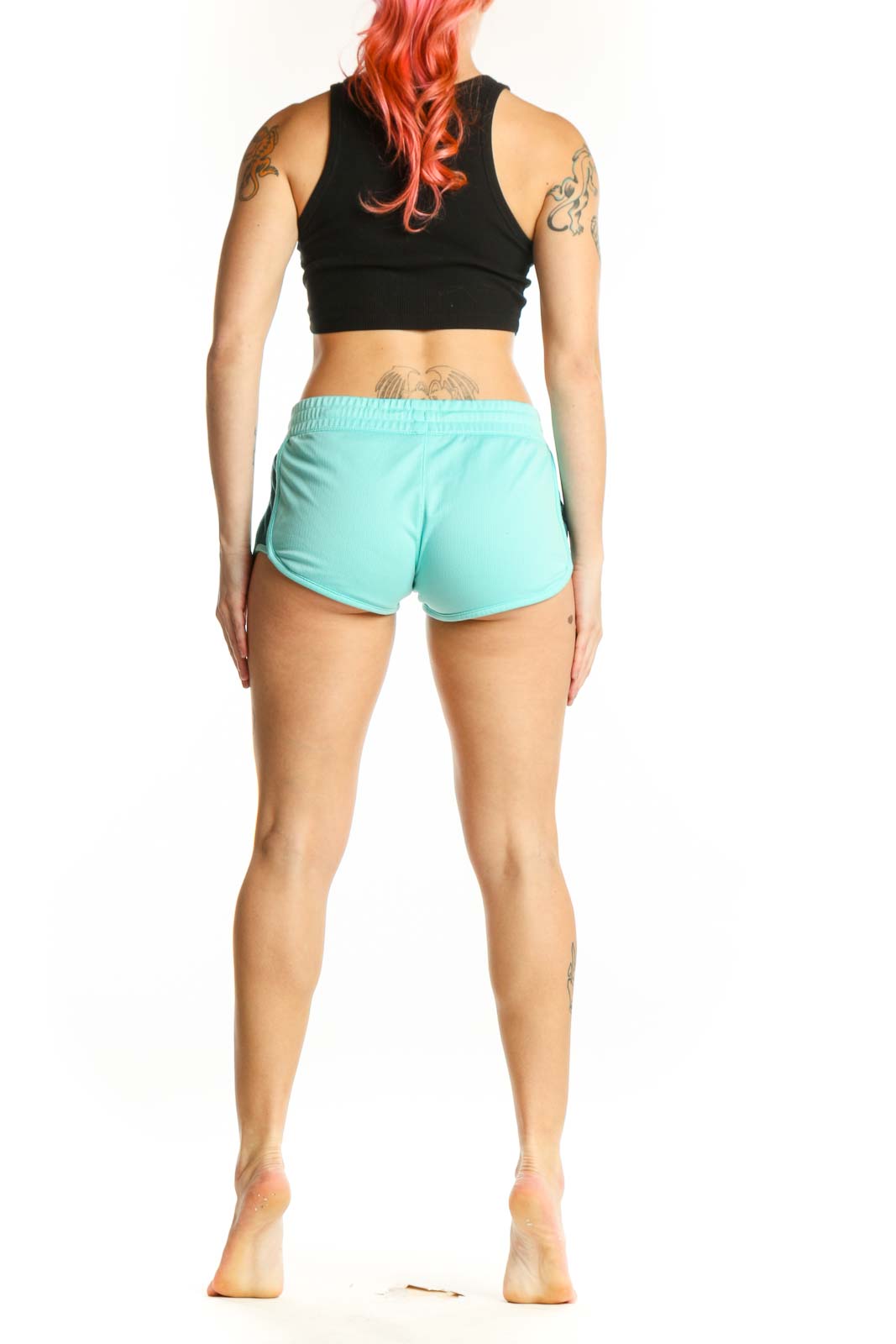 Back view of turquoise Nike athletic shorts showing fit and design details