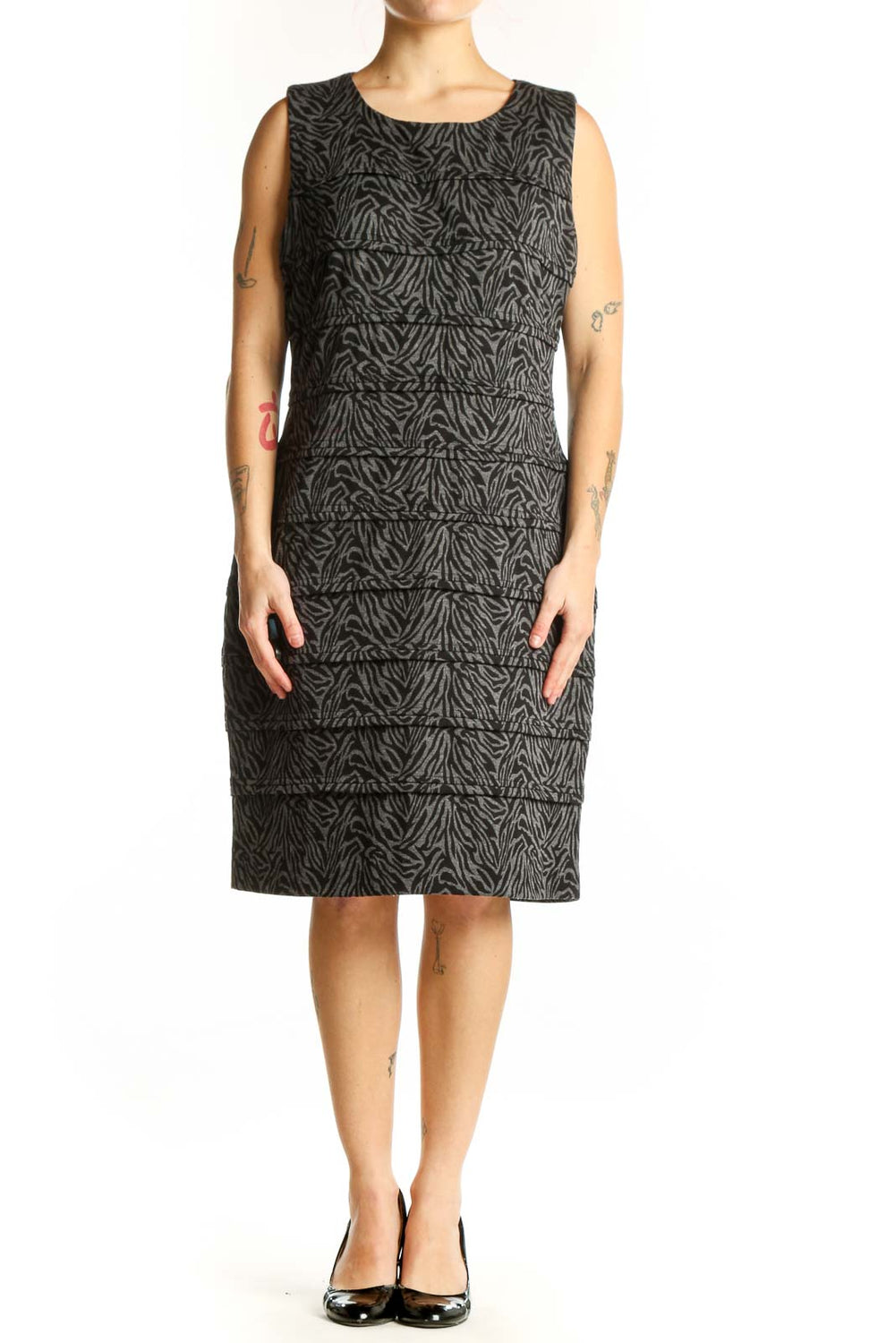 Black zebra print sleeveless shift dress by Calvin Klein, front view on model