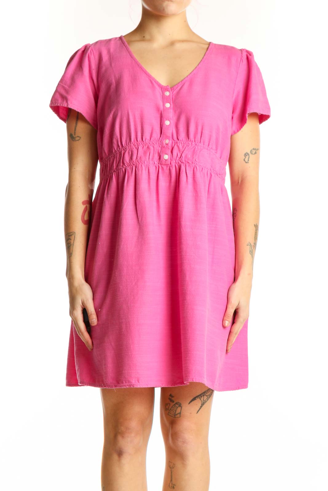 Pink short sleeve empire waist dress with button-front closure and ruching detail, front view