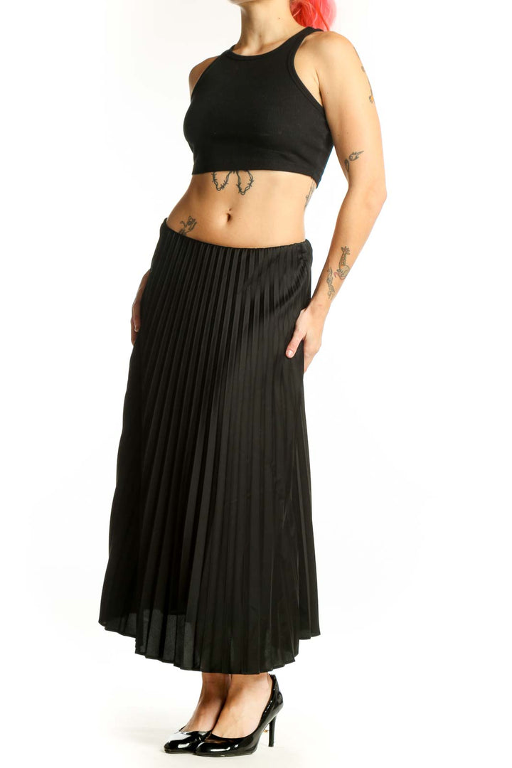 Black pleated midi skirt front view showing elegant knife pleats and flattering silhouette