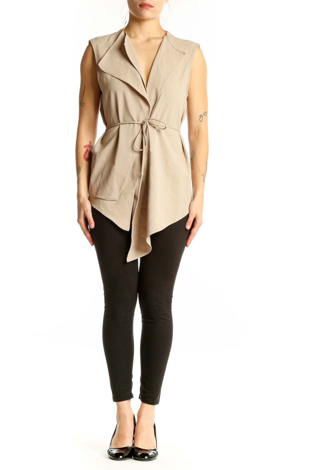 Beige sleeveless wrap vest top with tie waist and asymmetrical hem, front view on model