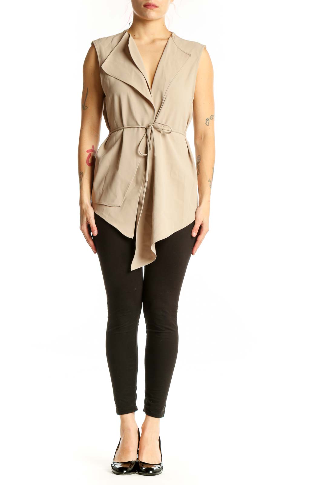 Beige sleeveless wrap vest top with tie waist and asymmetrical hem, front view on model