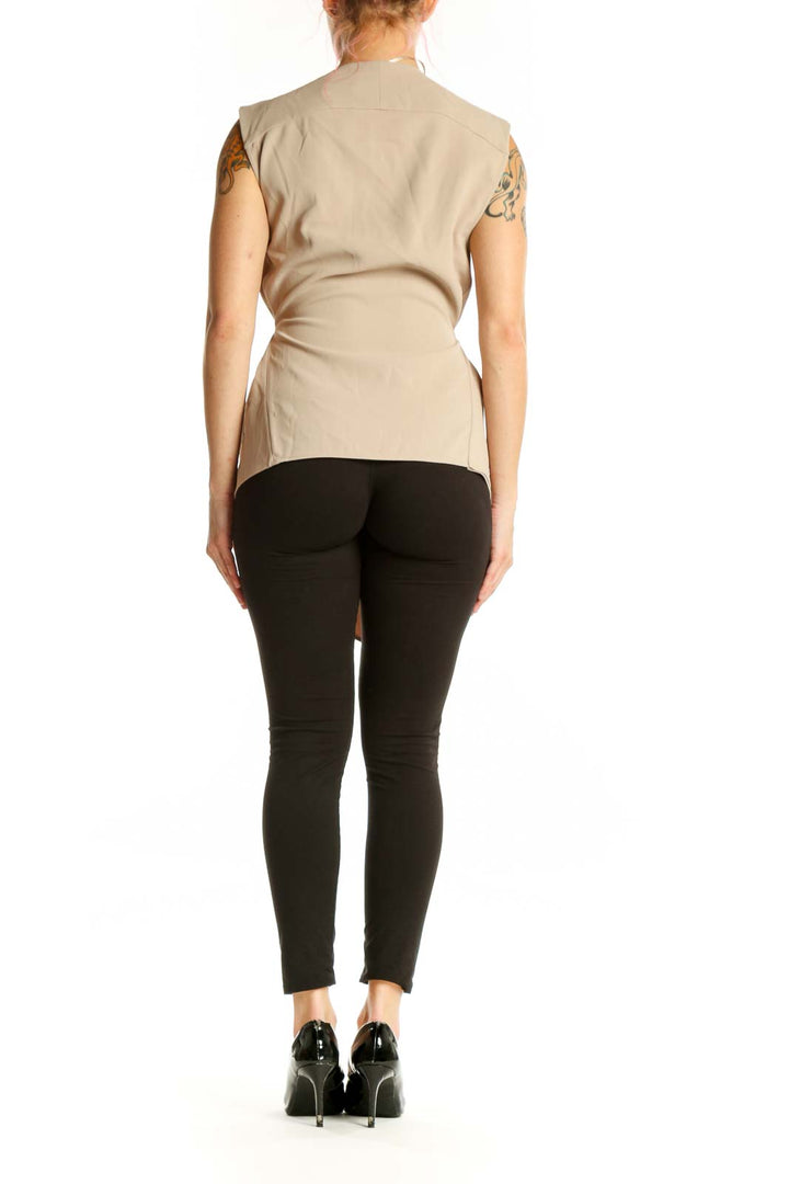 Beige sleeveless wrap vest top with tie waist closure, back view on model