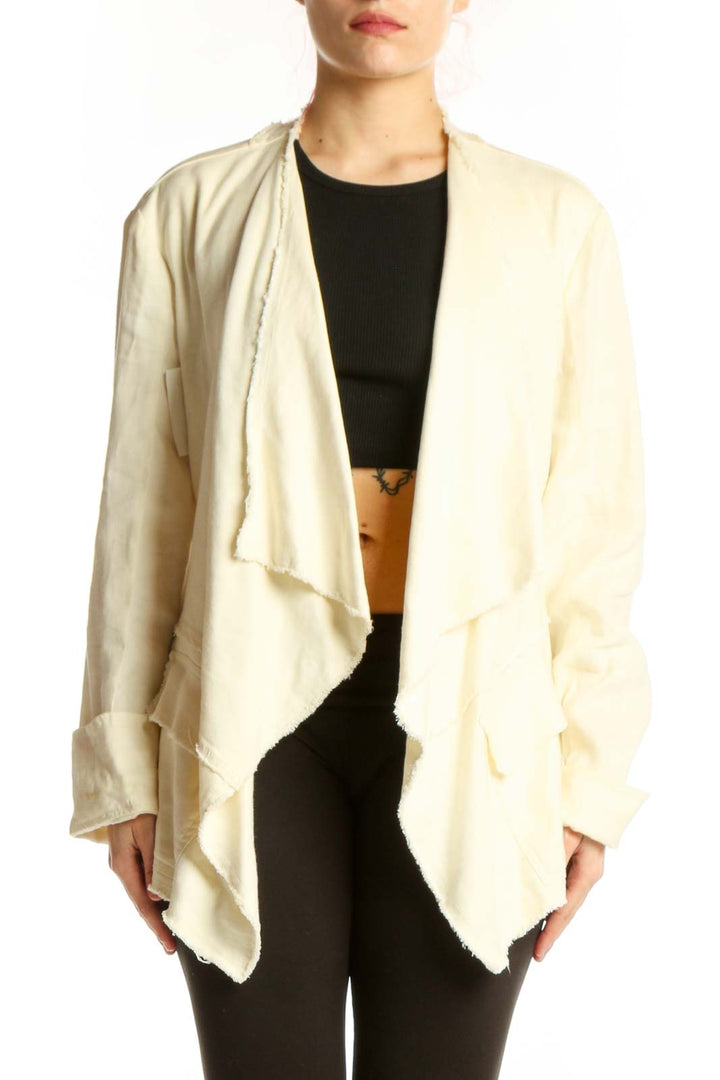 Cream draped cardigan jacket by Free People worn open over black top, showcasing flowing front design and relaxed fit