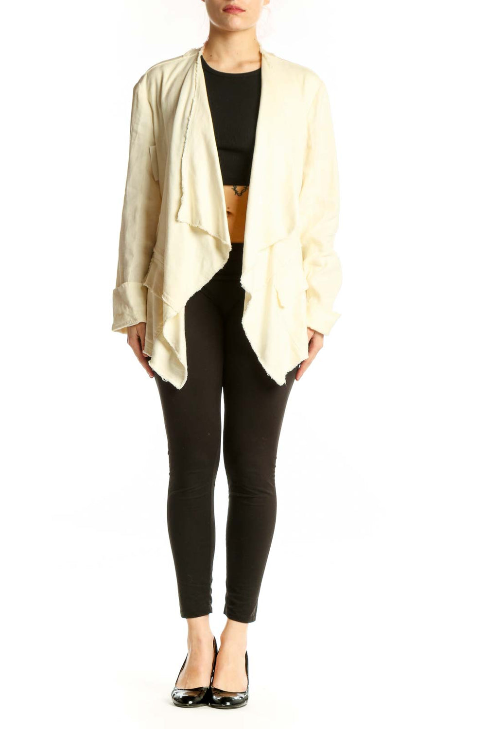 Cream draped cardigan jacket by Free People worn open over black top, showcasing flowing front design and relaxed fit