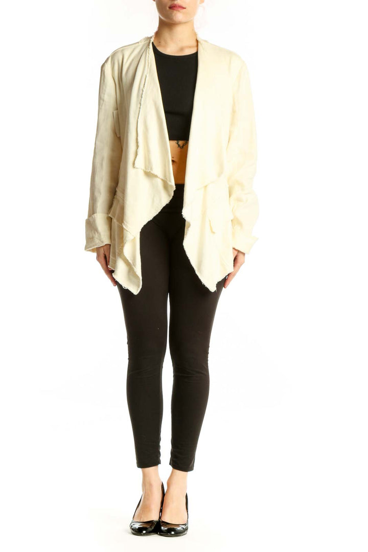 Cream draped cardigan jacket by Free People worn open over black top, showcasing flowing front design and relaxed fit