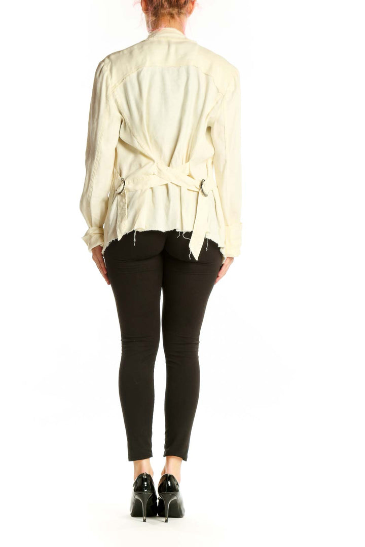 Back view of cream draped cardigan jacket by Free People displaying elegant draping and open-back silhouette