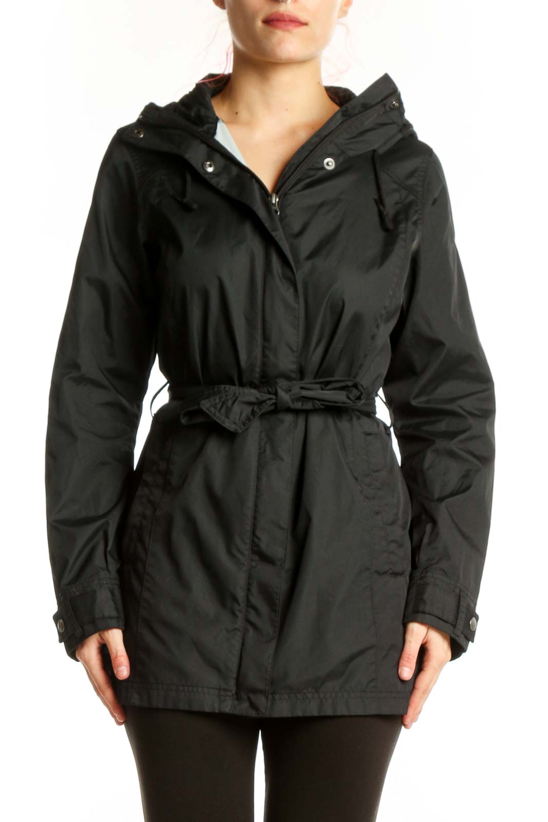 Black hooded rain jacket with cinching waist belt, front view on model