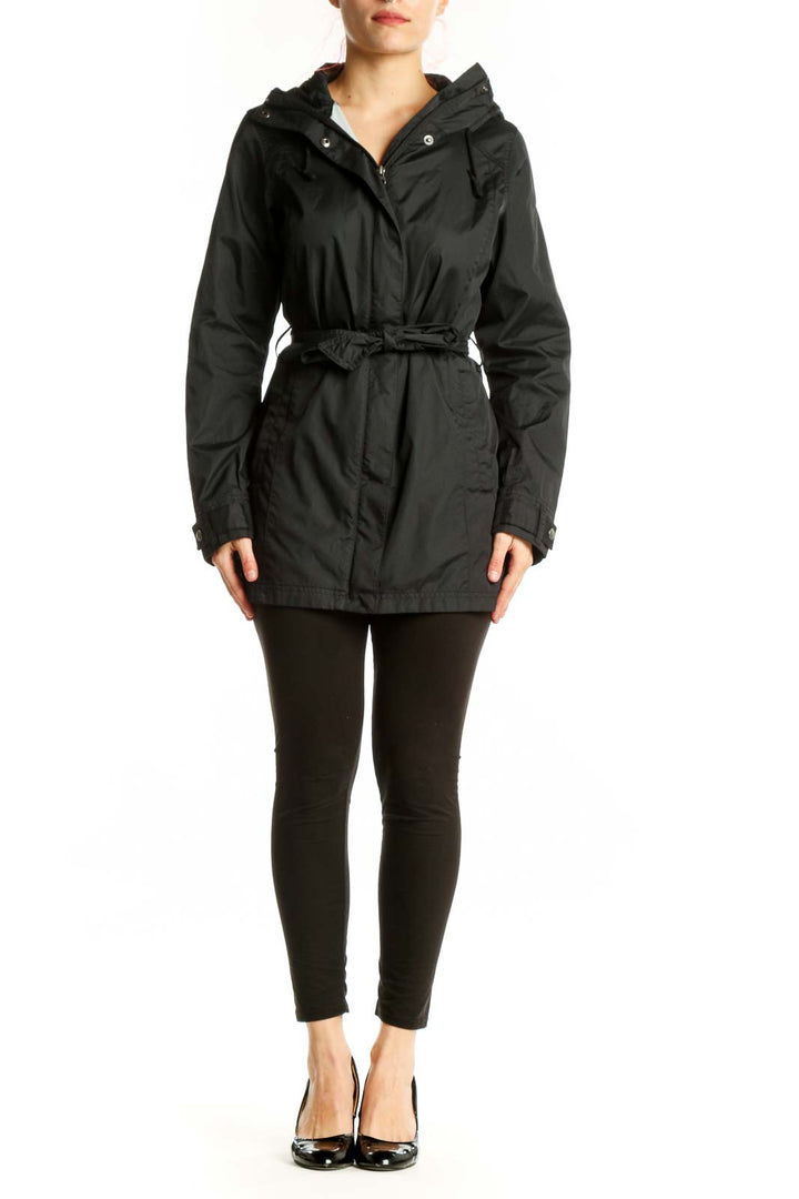 Black hooded rain jacket with cinching waist belt, front view on model