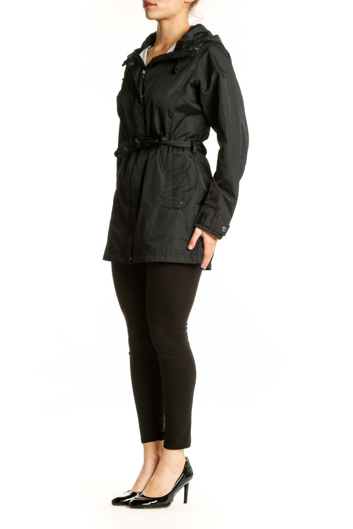 Black hooded rain jacket with cinching waist belt, front view on model