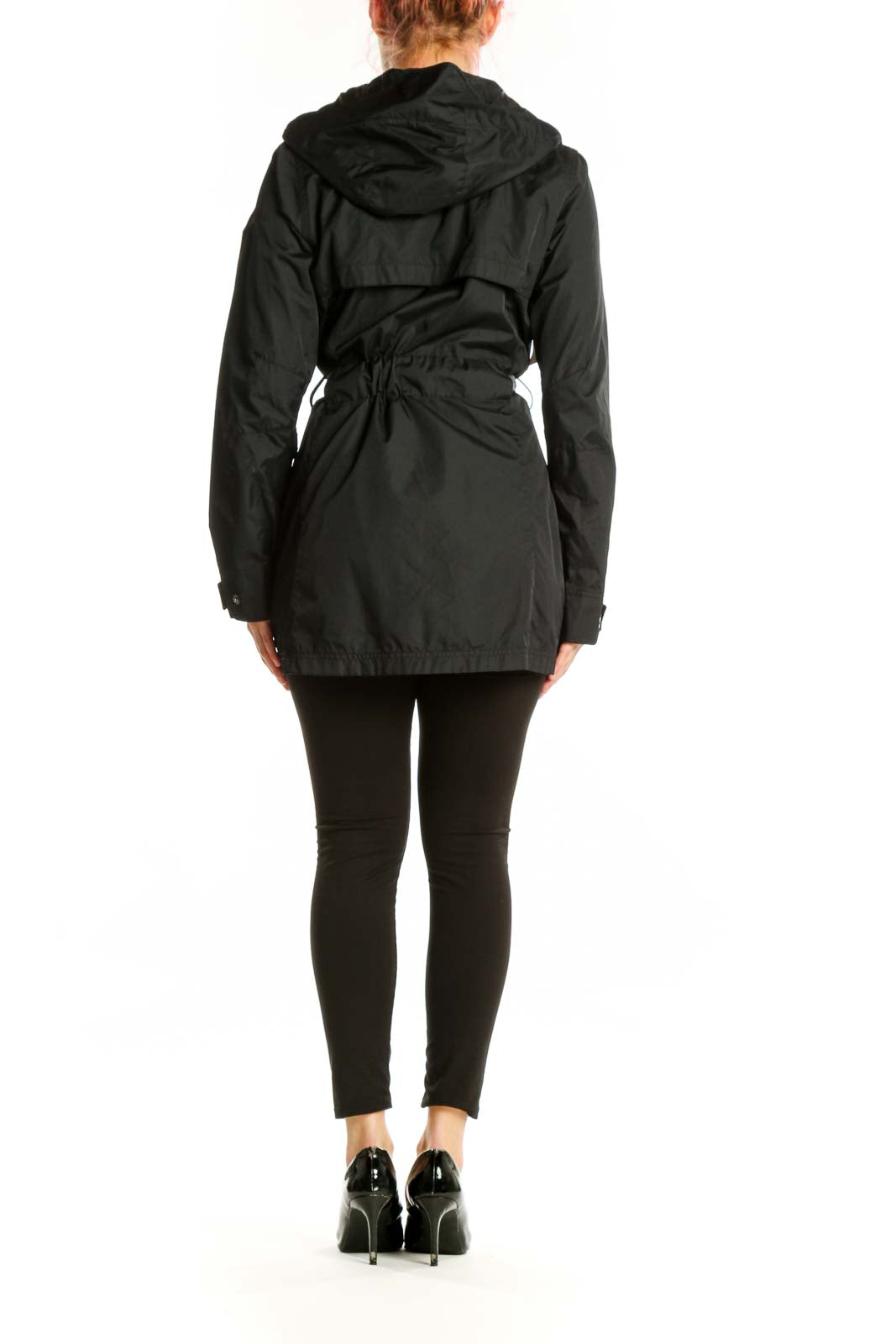 Black hooded rain jacket with cinching waist belt, back view on model