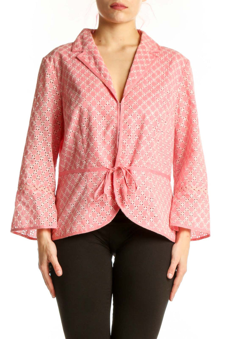 Pink geometric cotton blazer with white pattern and wrap-front tie closure, worn on model