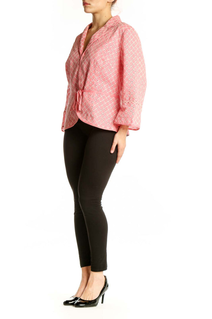 Pink geometric cotton blazer with white pattern and wrap-front tie closure, worn on model