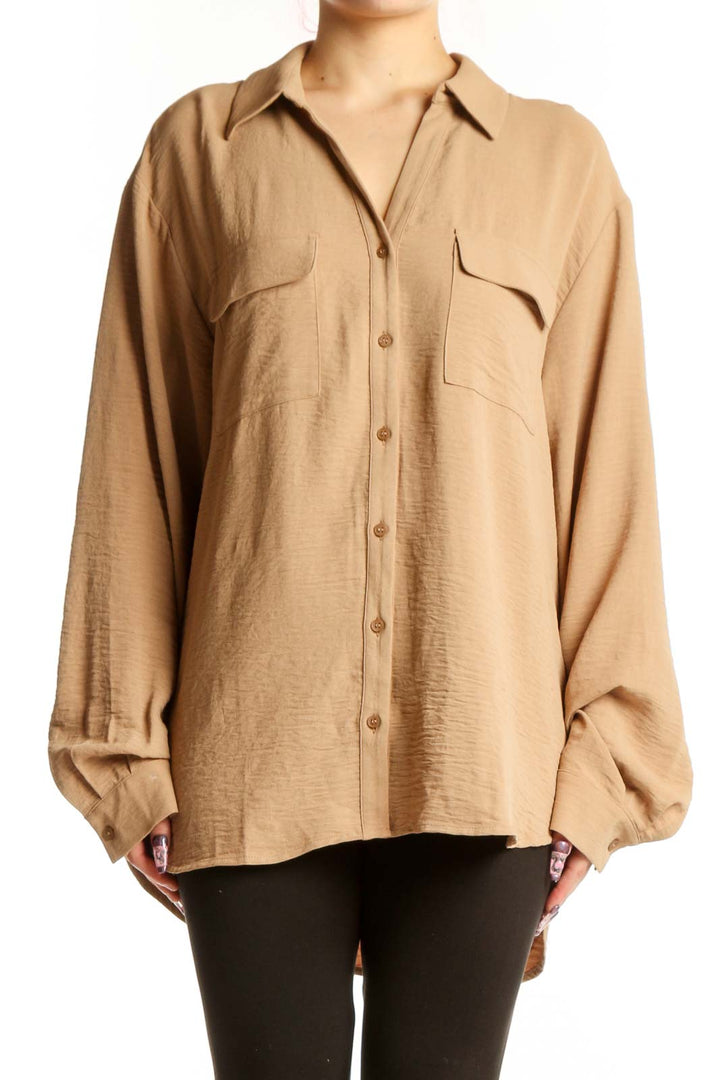 Beige Pleione button-up shirt with chest pockets and collared neckline, front view on model