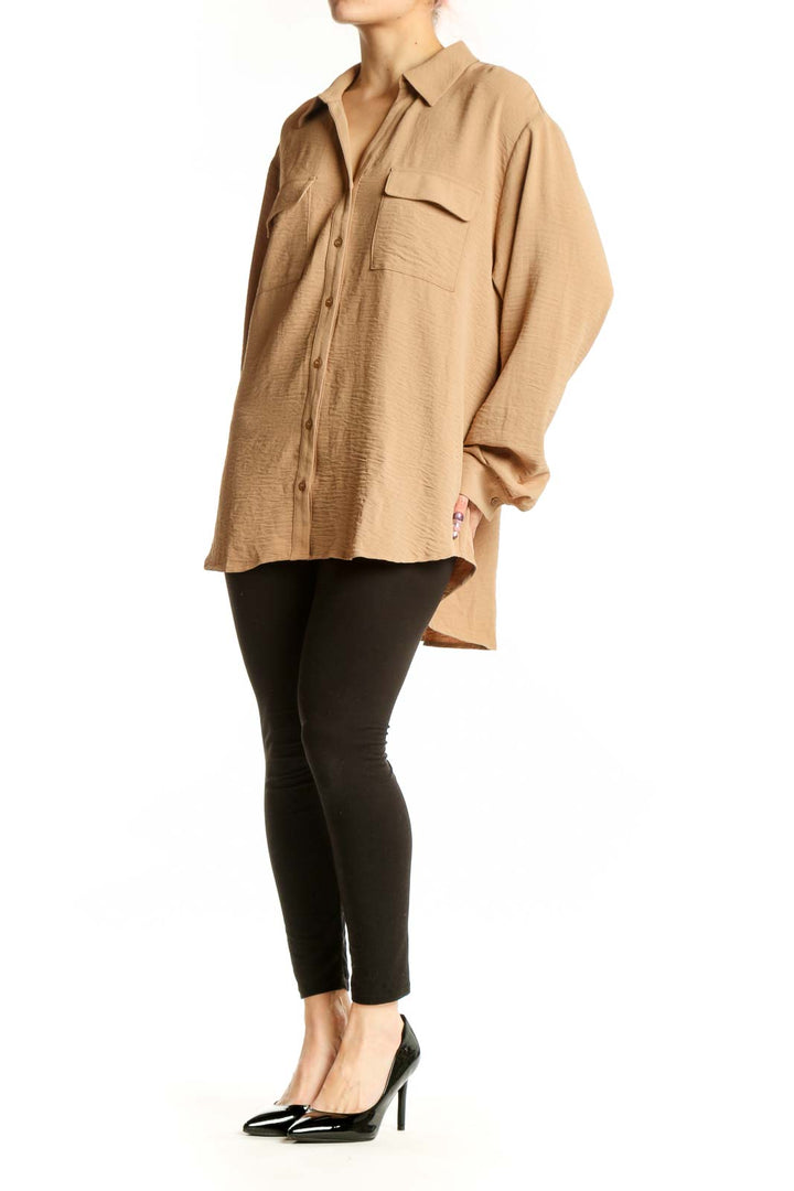 Beige Pleione button-up shirt with chest pockets and collared neckline, front view on model