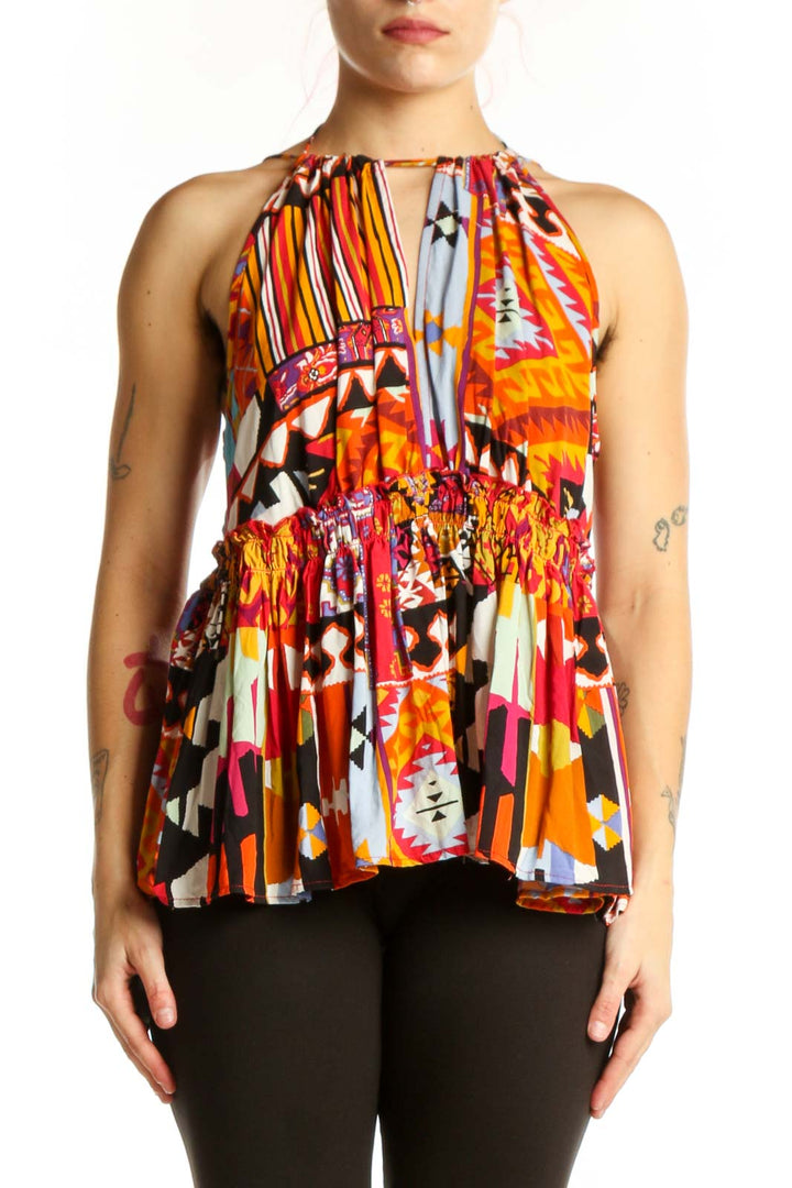 Front view of multicolor abstract halter top with bold geometric and striped patterns in orange, red, yellow, and black