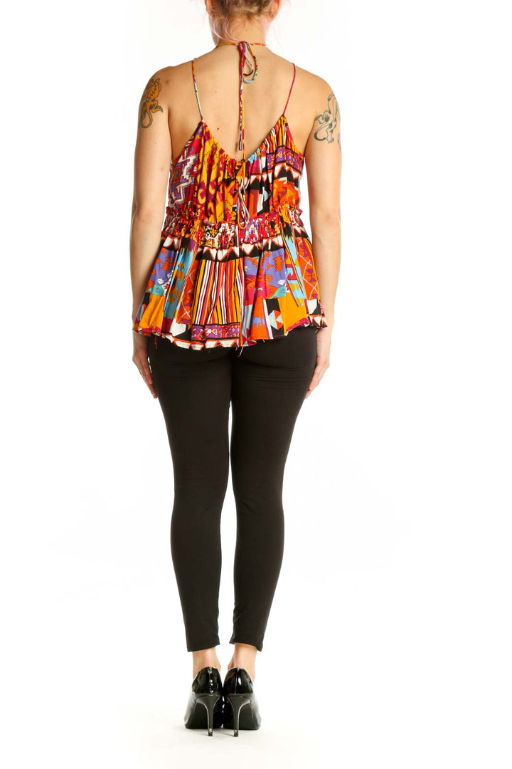 Back view of multicolor abstract halter top showing pleated silhouette and vibrant print design