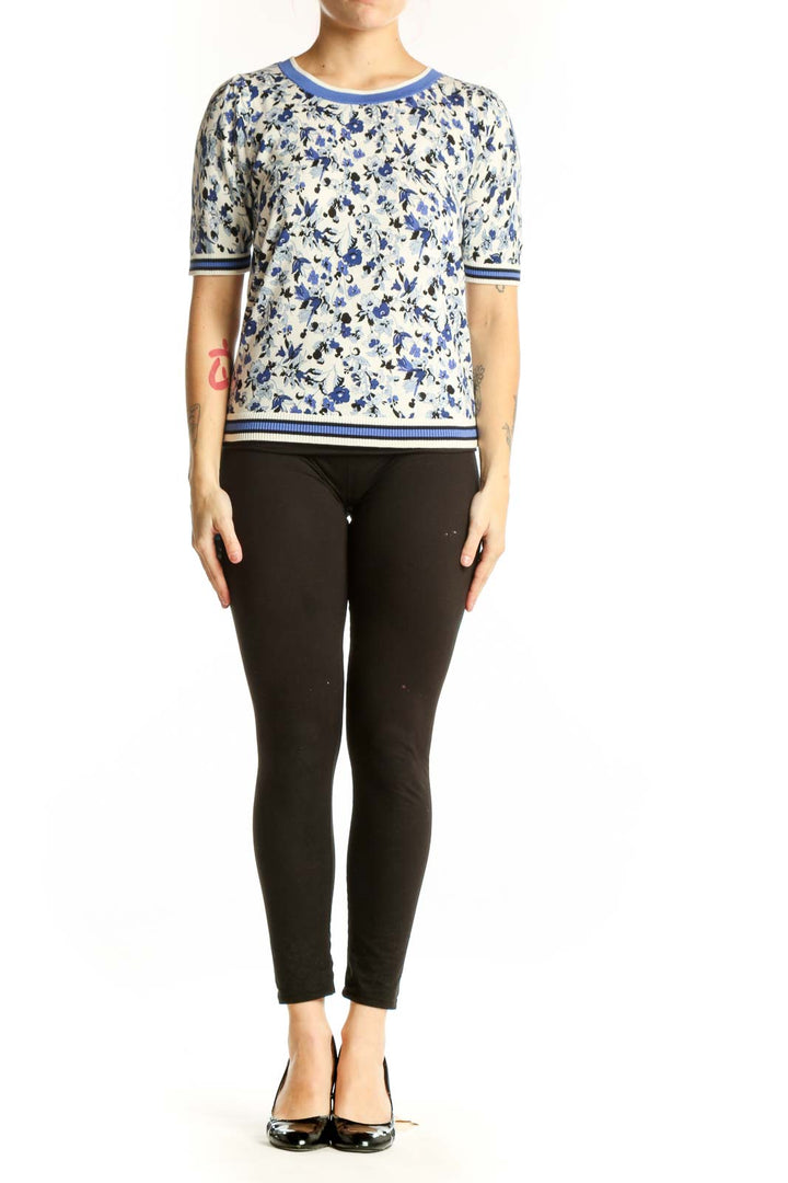 Blue and cream floral print short-sleeve top with striped ribbed neckline and sleeves, front view
