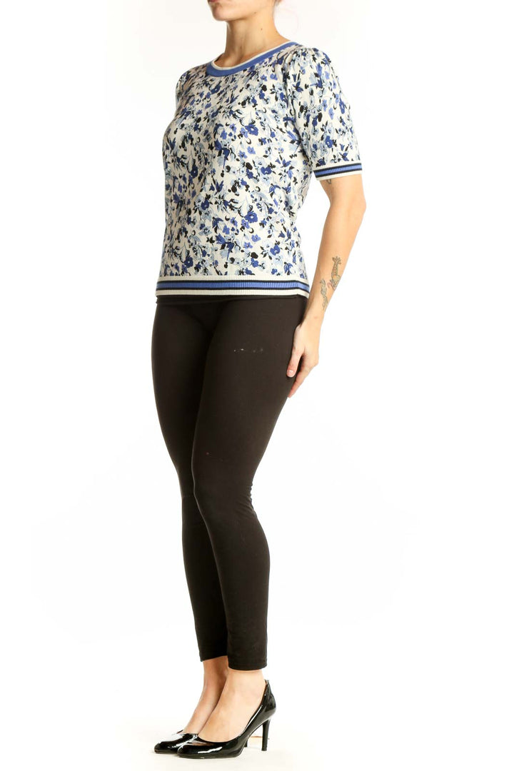 Blue and cream floral print short-sleeve top with striped ribbed neckline and sleeves, front view