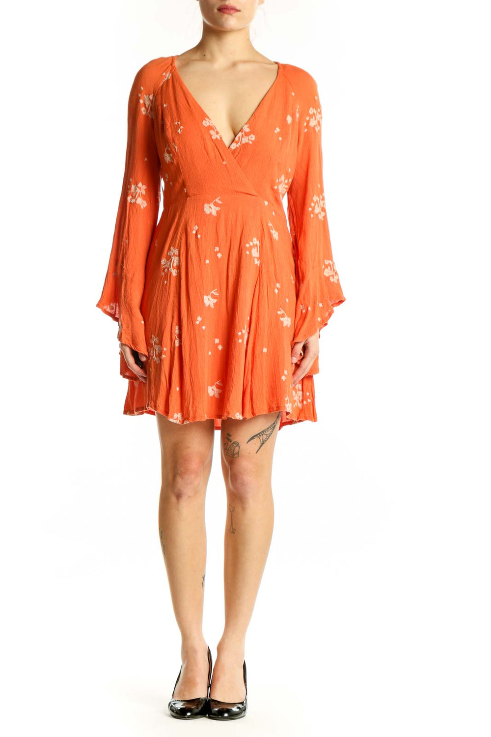 Front view of orange floral wrap dress with bell sleeves and V-neckline by Free People